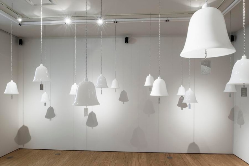 Marie Orensanz, ...in honor... of whom?, 1999-2015, 20 white opaline bells (9.5 x 10.2 in each) with stainless steel tags (3.1 x 1.8 in each), Installation view, 2015.