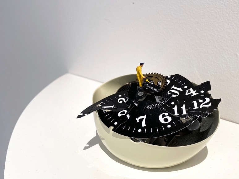 Liliana Porter, To Fix It [Man in Yellow], 2020. Broken table clock and figurine, 3 x 4 1/2 x 3 in. (7.6 x 11.4 x 7.6 cm.)