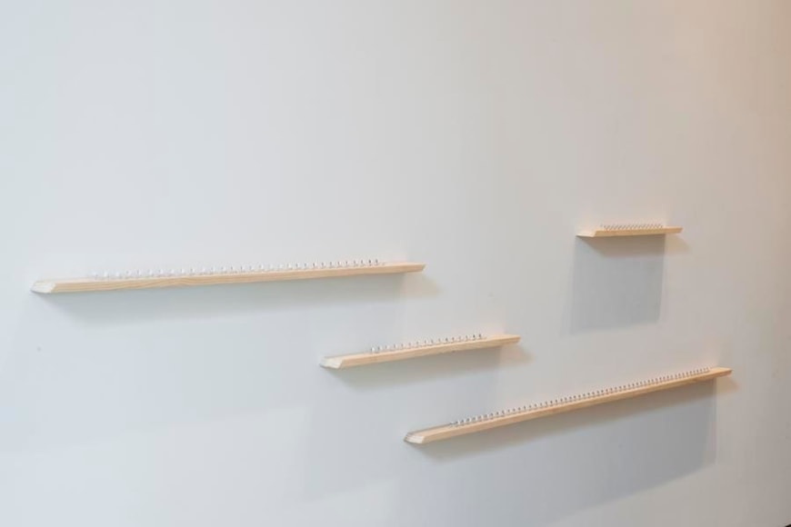Pedro Tyler, La distancia mas corta, 2014. Metal measuring tape and wood, Variable dimensions.