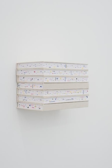 Marco Maggi, Stacking Quotes, 2013. Cuts on printed stickers in 7 notebooks with canvas cover, invisible shelf,  5 1/2 in. x 11 in. x 7 in.