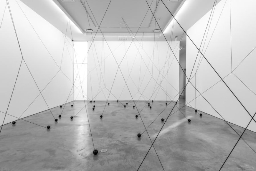 Magdalena Fern&aacute;ndez, 2i000.017, 2017. Iron spheres with black elastic cord, variable dimensions