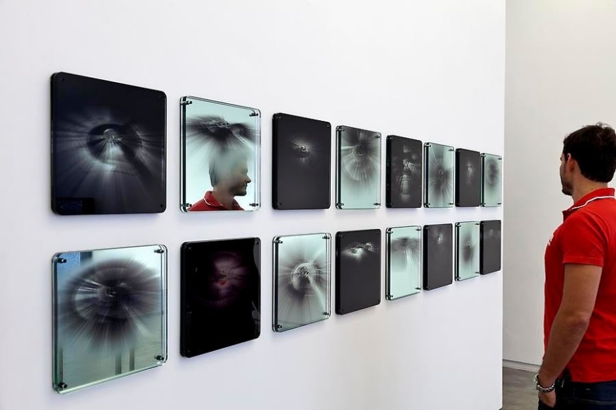 Ana Maria Tavares, Eclipse, 2011. From the series Hier&oacute;glifos Sociais. UV printing on glass, mirror, and rubber. 35 cm x 80 cm x 2.5 cm.