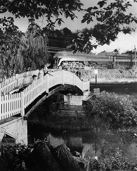 The Keith children fishing as train no. 2 passes. Lithia, Virginia 1955