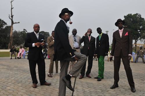 Daniele Tamagni. Sapeurs posing in front of Memoria Savorgnan de Brazza, 2008.