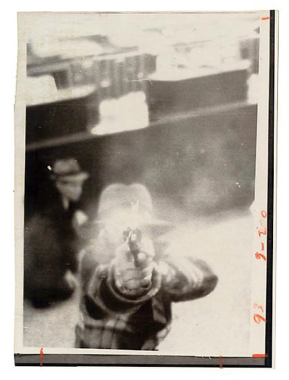 ANONYMOUS Bank robber shooting out the security camera.  1975.