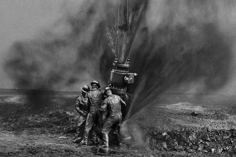 Workers Struggle to Remove Bolts, Oil Wells, Kuwait. 1991