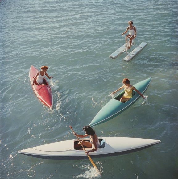 Slim Aarons, Lake Tahoe Trip, 1959: Young women canoeing on the Nevada side of Lake Tahoe