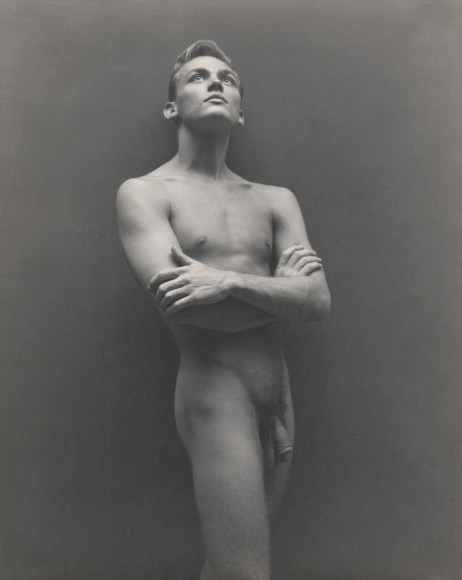 George Platt Lynes, Bill Harris, ​c. 1942. Male nude with arms crossed looking upward.