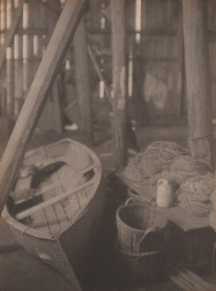 Doris Ulmann, Rowboat, Gloucester, Mass., ​c. 1920. Rowboat in a shed amongst baskets, rope, and wooden beams.