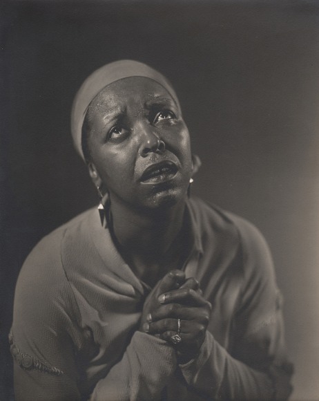Alfredo Valente, Ethel Waters, ​c. 1939. Subject looks up and to the right in a supplicating gesture with hands clasped by her chest.