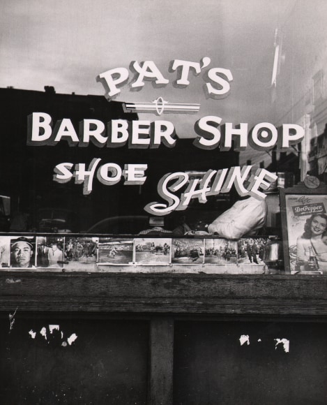 Marvin E. Newman, Chicago, ​1950. A painted window reads &quot;Pat's Barber Shop Shoe Shine&quot;.