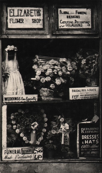 27. Beuford Smith, Harlem, NY, ​n.d. Window display of &quot;Elizabeth's Flower Shop&quot; with various floral arrangements on offer.