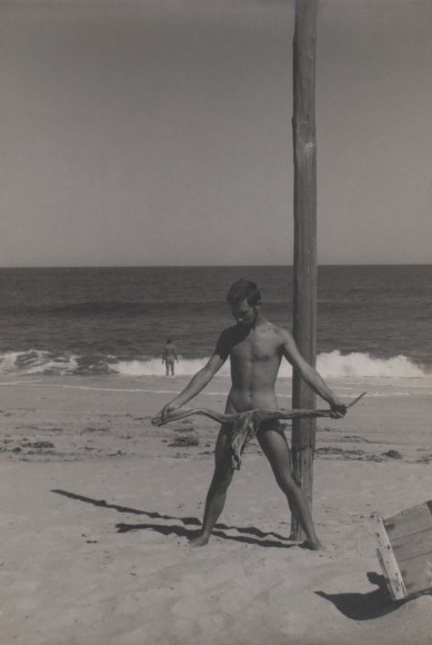 PaJaMa, George Tooker &amp; Jared French (?), Nantucket, ​c. 1945. Nude male figure stands in the foreground by a wooden post, holding a piece of driftwood in front of him. Another nude man in the background, back to the camera, walks into the sea.