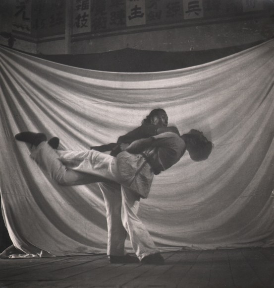 50. Cecil Beaton, Chinese College of Physical Training, 1945. Two figures, blurred with motion, engaged in karate-type fighting.