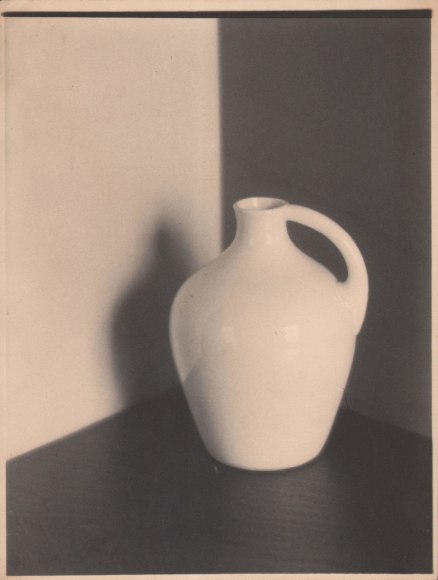 Bernard Shea Horne, Untitled, c. 1916&ndash;1917. A white vessel on a black surface in the corner of two walls. It casts a shadow on the left wall.