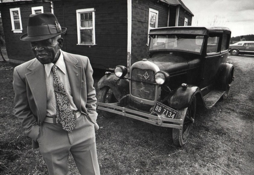 30. Ozier Muhammad (African-American, b. 1950), Hilliard McMoore, 106 years old with his 1929 Model &ldquo;A&rdquo; Ford, Rock Hill, South Carolina, 1974