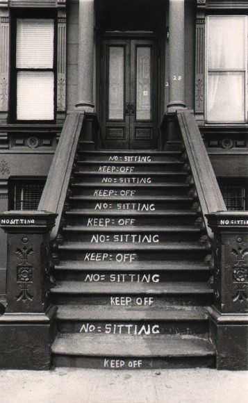 26. Beuford Smith, NO and KEEP OFF, Harlem, ​1982. A building stoop with &quot;No sitting&quot; and &quot;Keep off&quot; written on alternating steps.