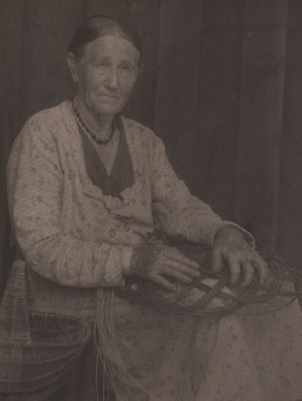09. Doris Ulmann, Untitled (Basket weaver), ​1928&ndash;1934. Seated woman weaving a basket in her lap.