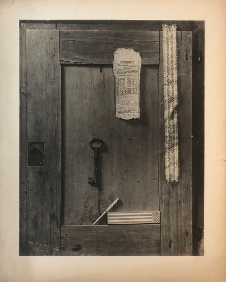 Kenneth Heilbron, Trompe L'Oeil, ​c. 1954. Still life featuring a key, ribbon, newspaper clipping, and matches against a wooden door.