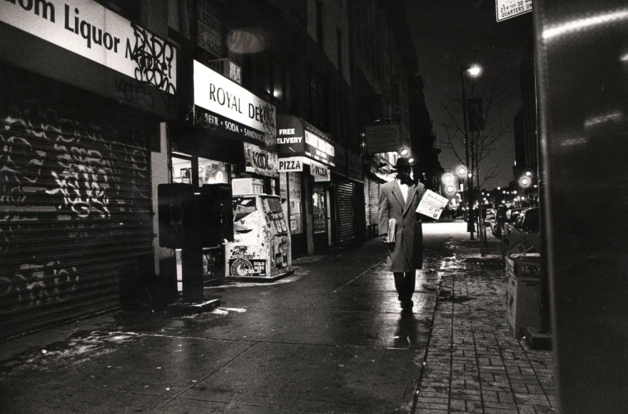18. Muhammad Speaks After Hours: A member of the National of Islam sells the Final Call, also known in the later part of the 20th Century as Muhammad Speaks, in the late evening on 125th Street, Harlem, New York, 1994.