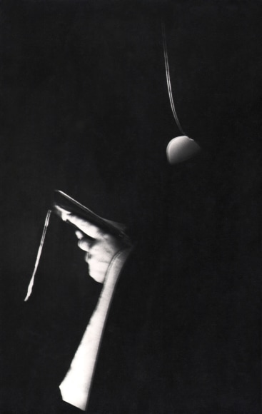 Ulisse Bezzi, In Preghiera, ​1970. Dark abstract profile of a hooded figure holding a small book.