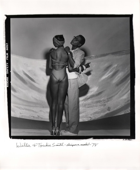 Anthony Barboza, Willi &amp; Toukie Smith - Designer &amp; Model, 1978. Subjects stand in center of square frame holding each other. Toukie stands with back to camera wearing a swimsuit. Willi faces left. Both have heads facing left.