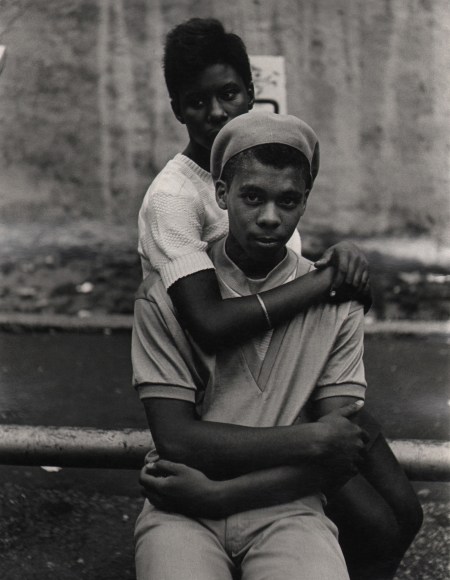 03. Beuford Smith, Lower East Side, ​1968. A young seated couple; the young woman sits behind the young man with arms around his neck.