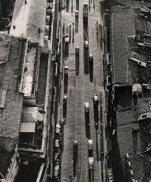 Nino Migliori, Bologna, 1958. A street with vehicles photographed from above.