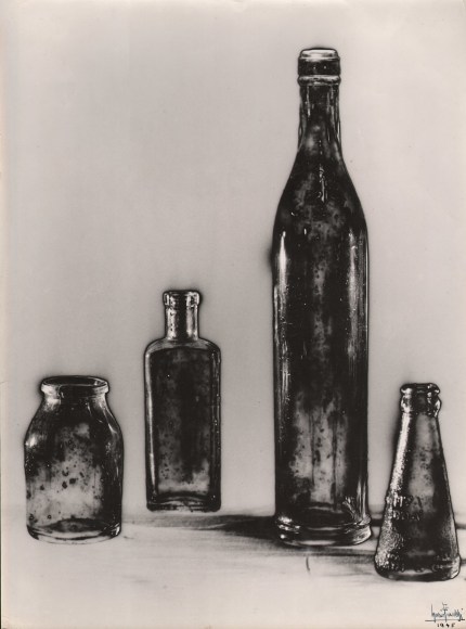 Mario Finazzi, Bottiglie, 'Hot Line,' ​1945. Four glass bottles of various sizes. Solarized image on white background.