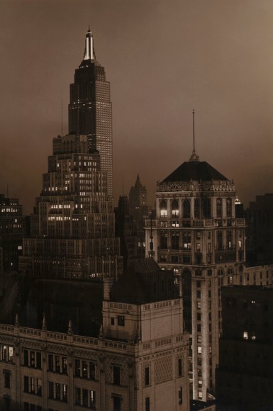 Paul J. Woolf, Times Building Looking South, ​c. 1935. Night time cityscape in a vertical composition.