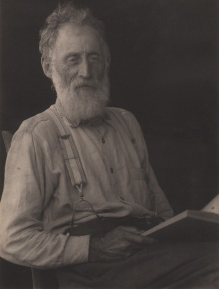 Doris Ulmann, Untitled (Appalachian man), ​1928&ndash;1934. Older bearded man in suspenders, seated and holding a book in his lap.