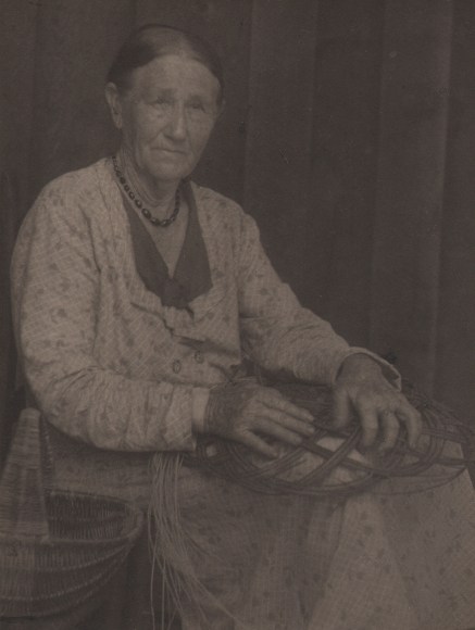 Doris Ulmann, Untitled (Basket weaver), 1928&ndash;1934. Seated woman weaving a basket in her lap.