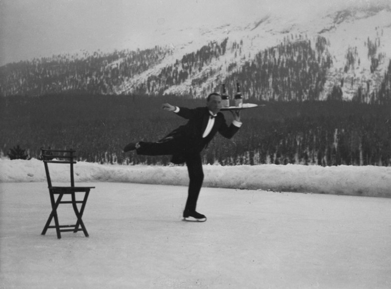 51.&nbsp;Alfred Eisenstaedt (1898-1995), Swiss waiter serves visitors on ice skates at St. Moritz, a fashionable winter resort in Switzerland, 1936