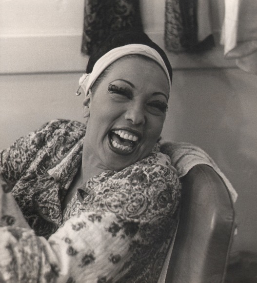 Florence Homolka, Josephine Baker, ​c. 1958. Subject is pictured seated and smiling, looking off to the right.