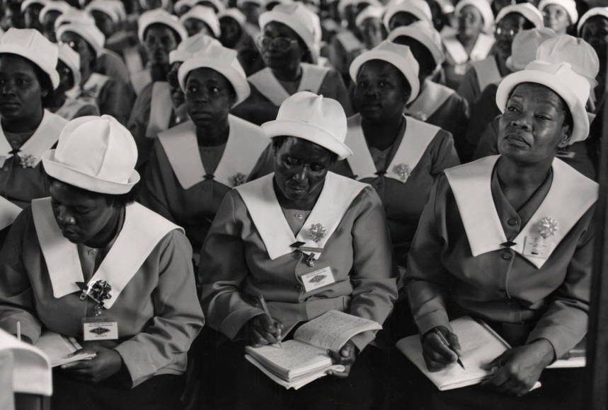 13. Women&rsquo;s Auxiliary Listening to Mandela: A lady&#039;s&nbsp;auxiliary listens attentively and takes notes as Nelson Mandela gives a campaign speech at this church in Pretoria, South Africa.