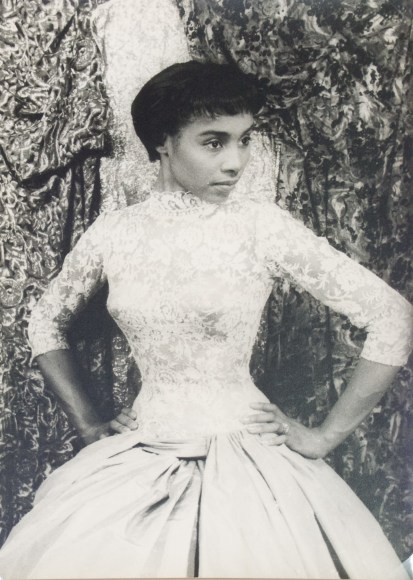 41. Carl Van Vechten, Diahann Carroll in House of Flowers, 1955. Three quarter-length portrait with subject in lace gown, looking to the right of the frame with hands on hips.