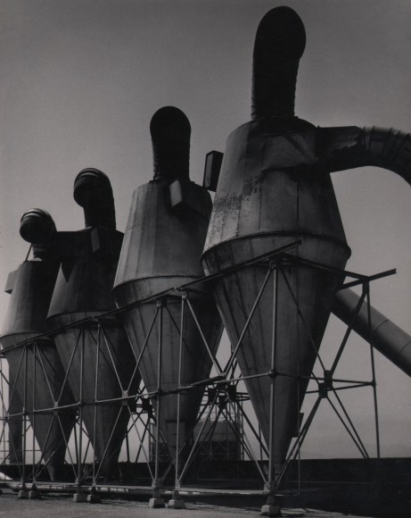 Harold Zegart, Untitled, ​c. 1958. A row of four large metal pieces of farming or industrial equipment.
