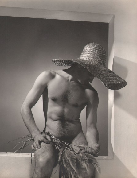 George Platt Lynes, Jos&eacute; Martinez, ​c. 1937. Male nude in a straw hat, seated in a window-like opening.