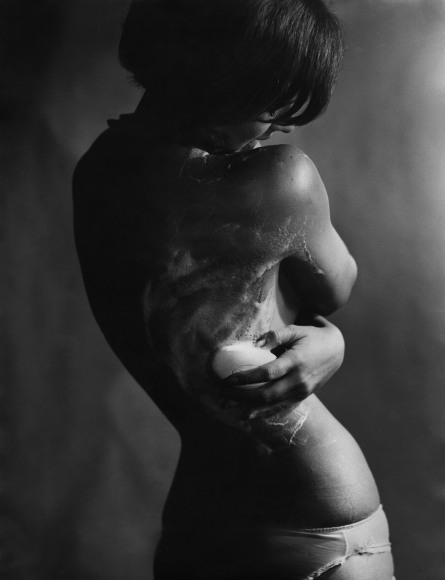 35. Lewis Morley, Astral Soap campaign, ​c. 1963. Rear torso view of a woman washing with bar soap.