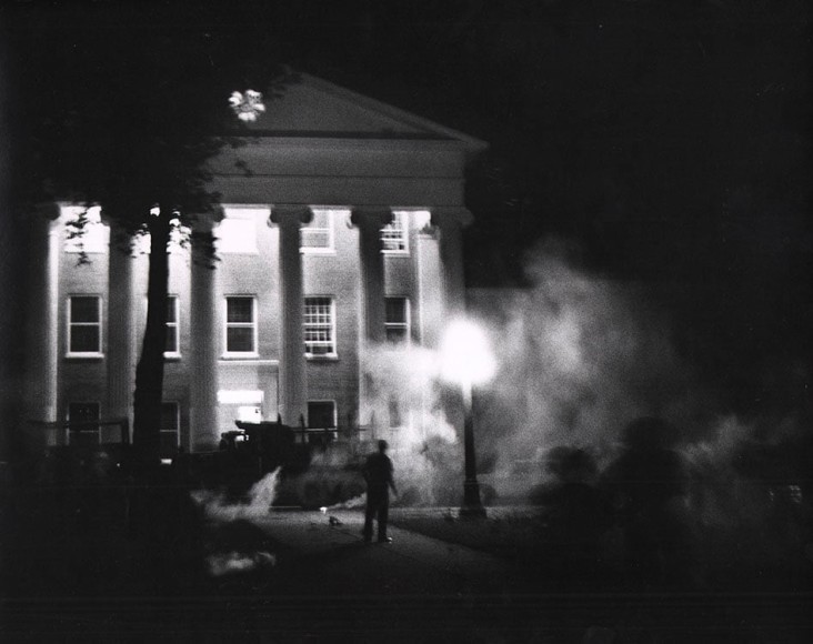 17.&nbsp;Flip Schulke (1930-2008), The Siege Starts: Clouds of tear gas eddy in the glare of burning cars, set afire by the crowd, as the mob attacks federal marshals surrounding the Lyceum, campus of the University of Mississippi, Oxford, Mississippi&nbsp;(Oct. 12, 1962 Issue, p. 34), 1962