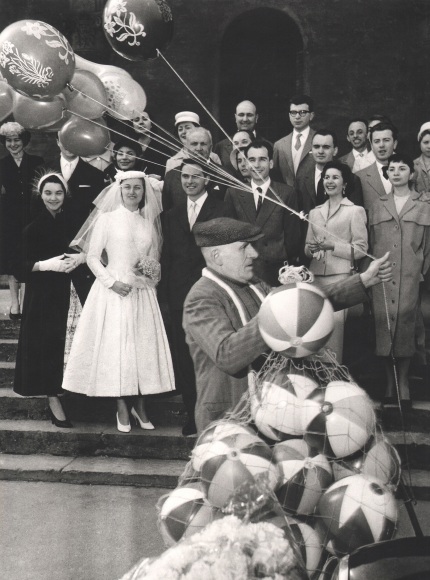 Nino Migliori, People of Emilia, 1952. A group poses for a wedding portrait as a balloon vendor walks through the foreground.