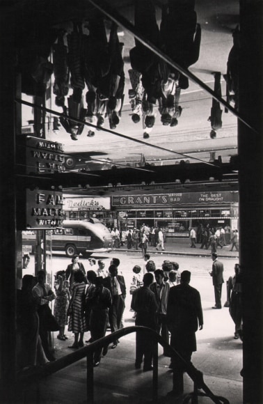 34. Fritz Neugass, 42nd Street, ​c. 1948. Patrons beneath a reflective outdoor overhang so that their mirror image is above them.