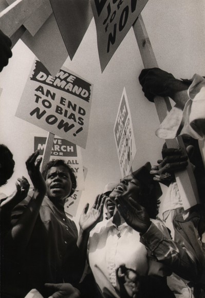 37. Flip Schulke, March on Washington, ​August 28, 1963. Crowd photographed from below holding signs such as &quot;We demand an end to bias now!&quot;