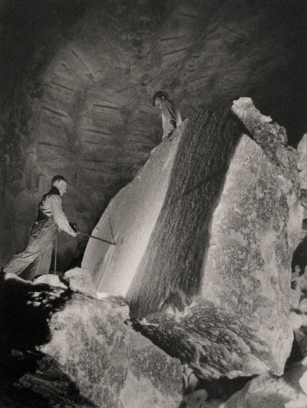 Harold Haliday Costain, Drilling a 60-ton Rocksalt Block, Avery Island, Louisiana, ​1934. One man to the left drilling into the block while another stands above.