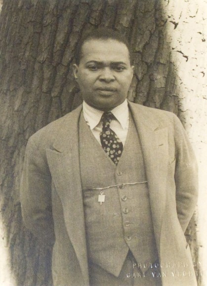 26. Carl Van Vechten, Countee Cullen, 1941. Waist-length portrait of subject in a three-piece suit, leaning against a tree with arms behind his back.
