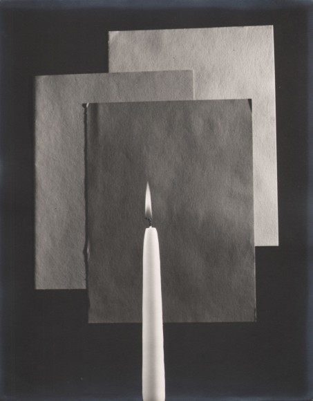 Edward Quigley, Still Life, ​1938. A lit white candle stands in front of three overlapping sheets of paper.