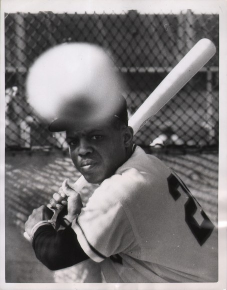 United Press Photo, A Pitcher of Willie, ​1958. Subject holds his baseball bat at the ready as a baseball (out of focus in the foreground) flies toward him.