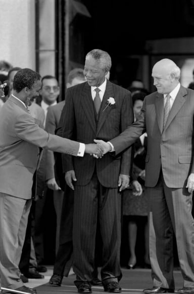 09. Mandela Inaugurated: Thabo Mbeki, Nelson Mandela and F.W. de Klerk shake hands at the presidential inauguration of Mr. Mandela in Pretoria, South Africa, 1994.