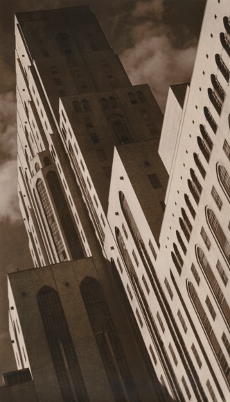 Paul J. Woolf, New York Hospital, ​c. 1935. Diagonal composition upper left to lower right, looking up at hospital building with cloudy skies behind.