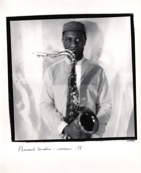 Anthony Barboza, Pharoah Sanders - Musician, ​1978. Subject stands in center of square frame, blurred with motion, holding a saxophone.